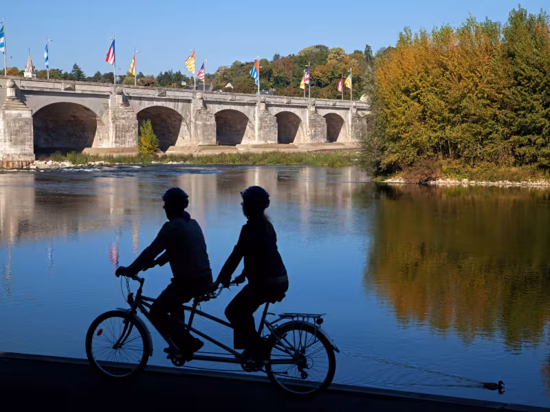 Cyclotouristes en tandem en bord de Loire devant le Pont Wilson